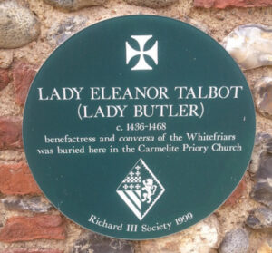 Green plaque on a wall about Eleanor Talbot